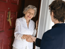 women greeting at door